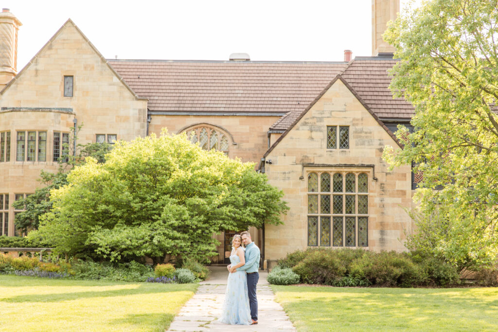 Engagement couple standing in front of the Paine Art Center in Oshkosh, Wisconsin.  