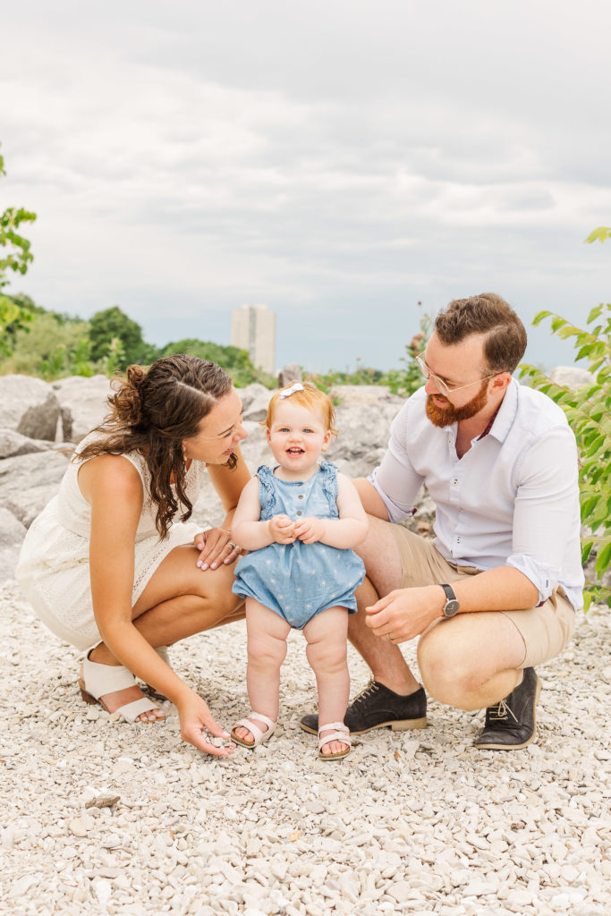 One year old playing with rocks with her parents in Milwaukee, Wisconsin. 