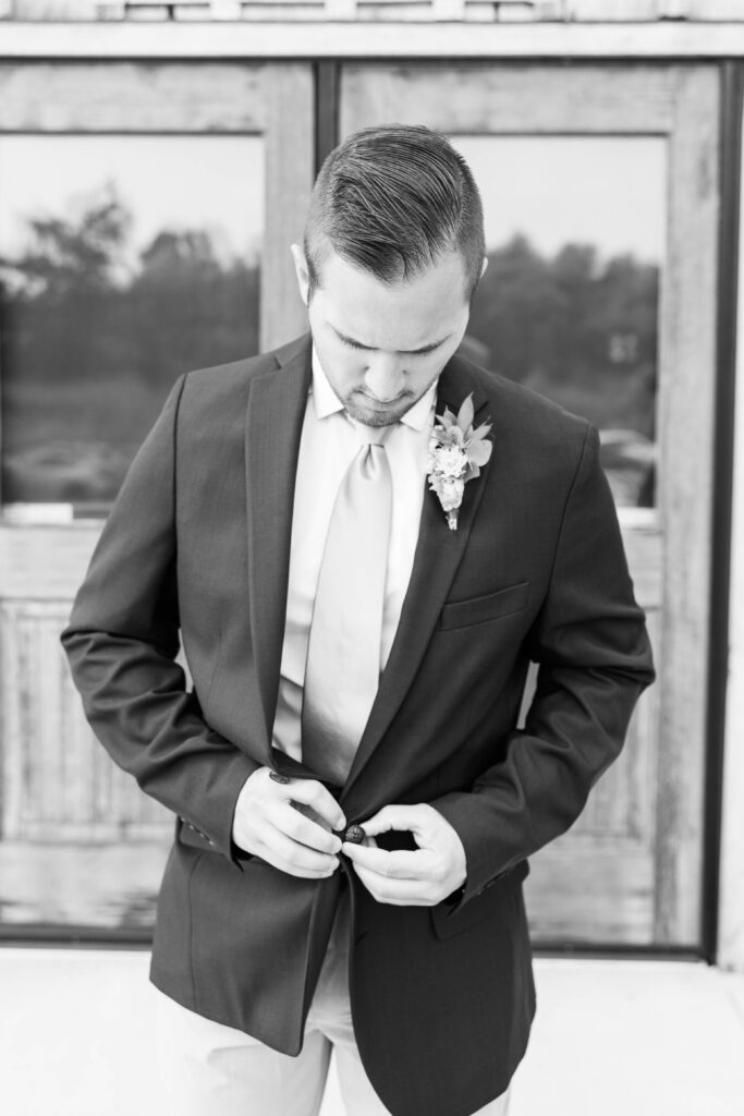 Groom buttoning jacket. 