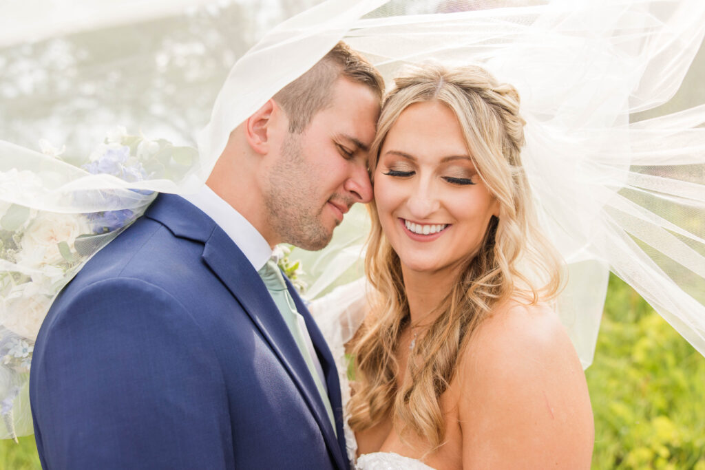 Bride and groom portraits under veil at the Bog in Saukville Wisconsin. Meredith Mutza Photography. 