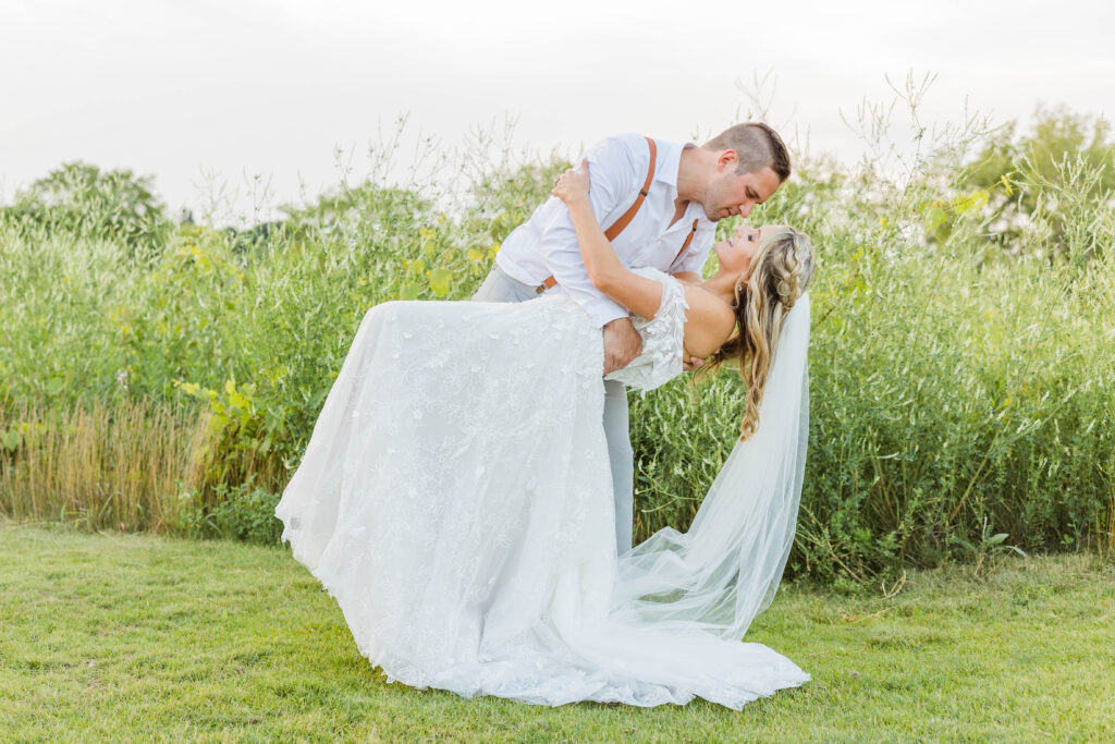 Bride and groom dip kiss the Bog, Wisconsin. 