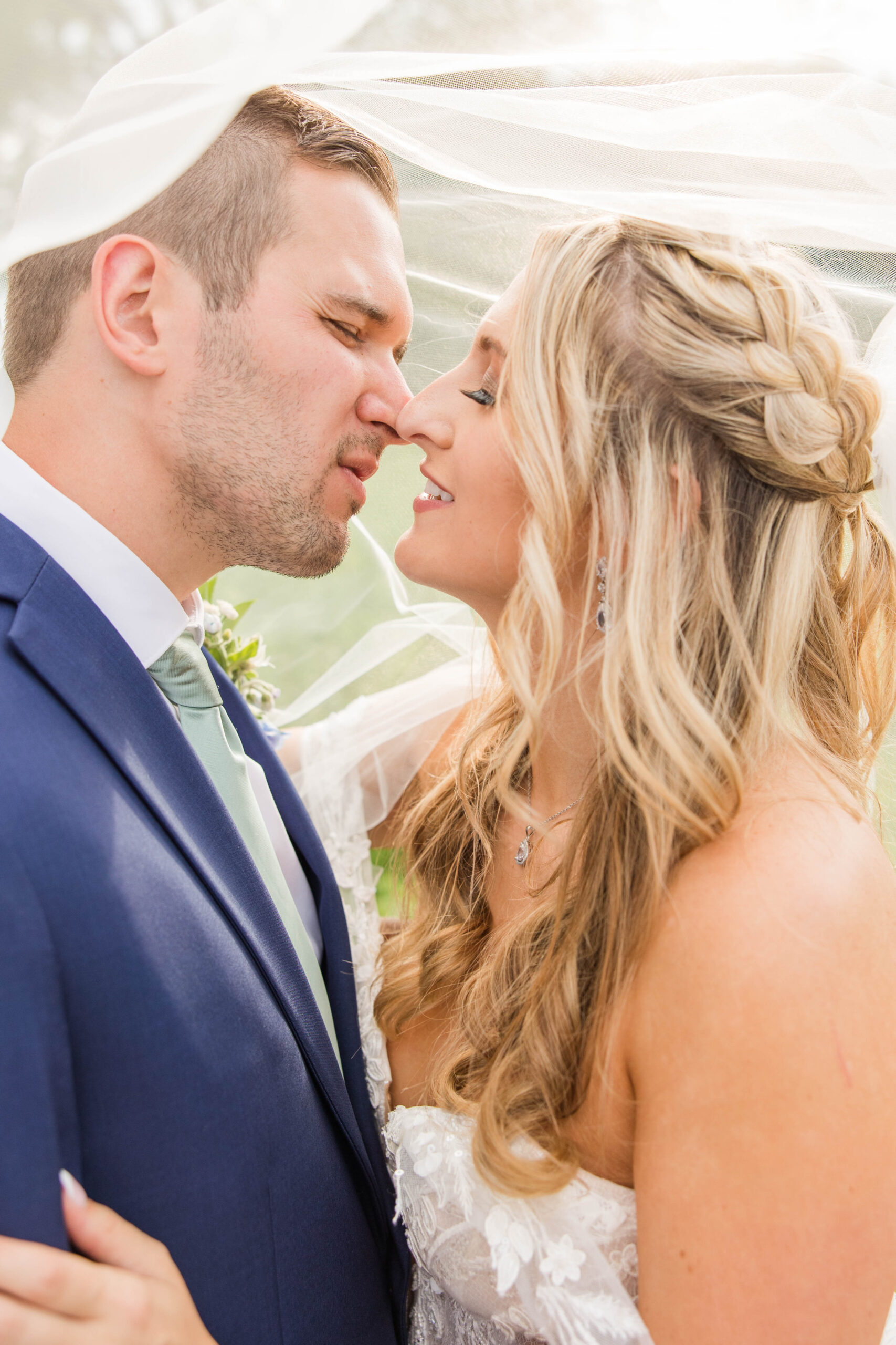 Bride and groom portraits under the veil on their wedding day at the Bog in Saukville, Wisconsin.