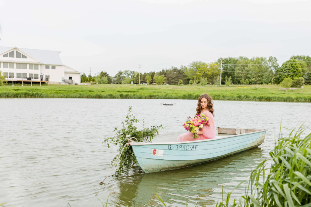 Bride in pink wedding gown in a blue paddle boat on a pond at Fete of Wales in Waukesha, Wisconsin.