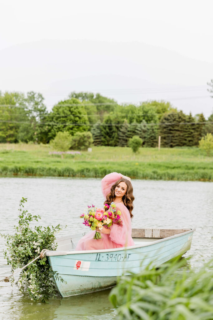 Bride in pink wedding gown in a blue paddle boat on a pond at Fete of Wales in Waukesha, Wisconsin.