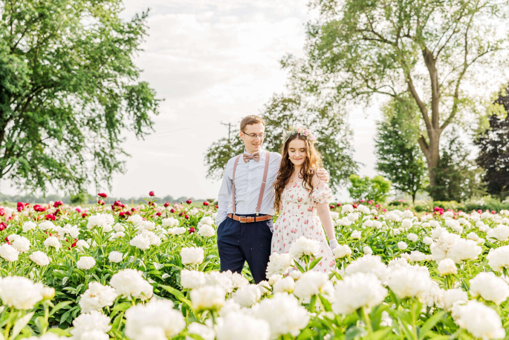 Anniversary couple walking through Ovans Peony Farm located outside of Madison, Wisconsin. 