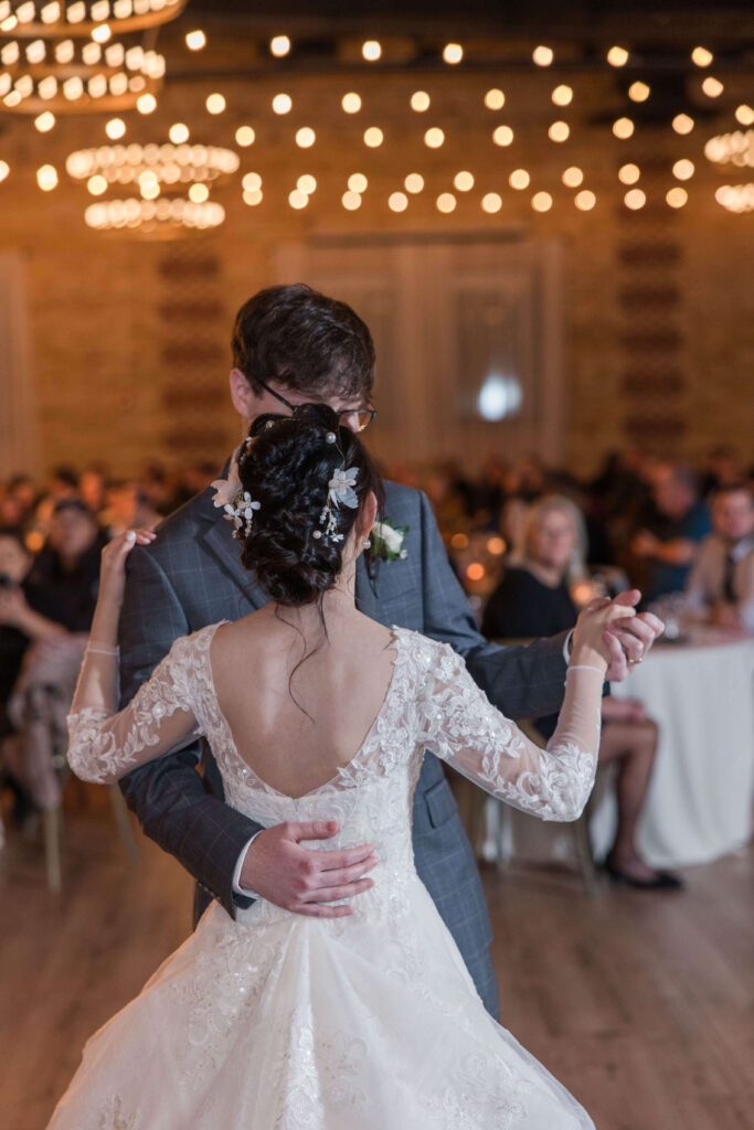 Bride and groom first dance twinkle lights at wedding reception at 10 South in Madison, Wisconsin. 