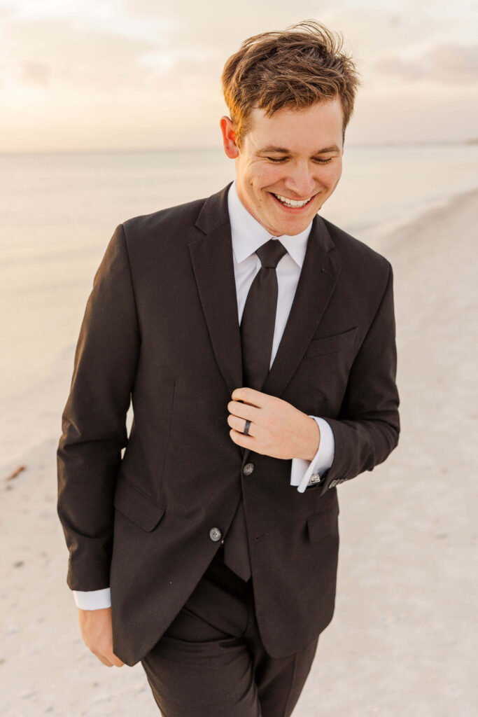 Groom laughing while getting ready destination wedding. 