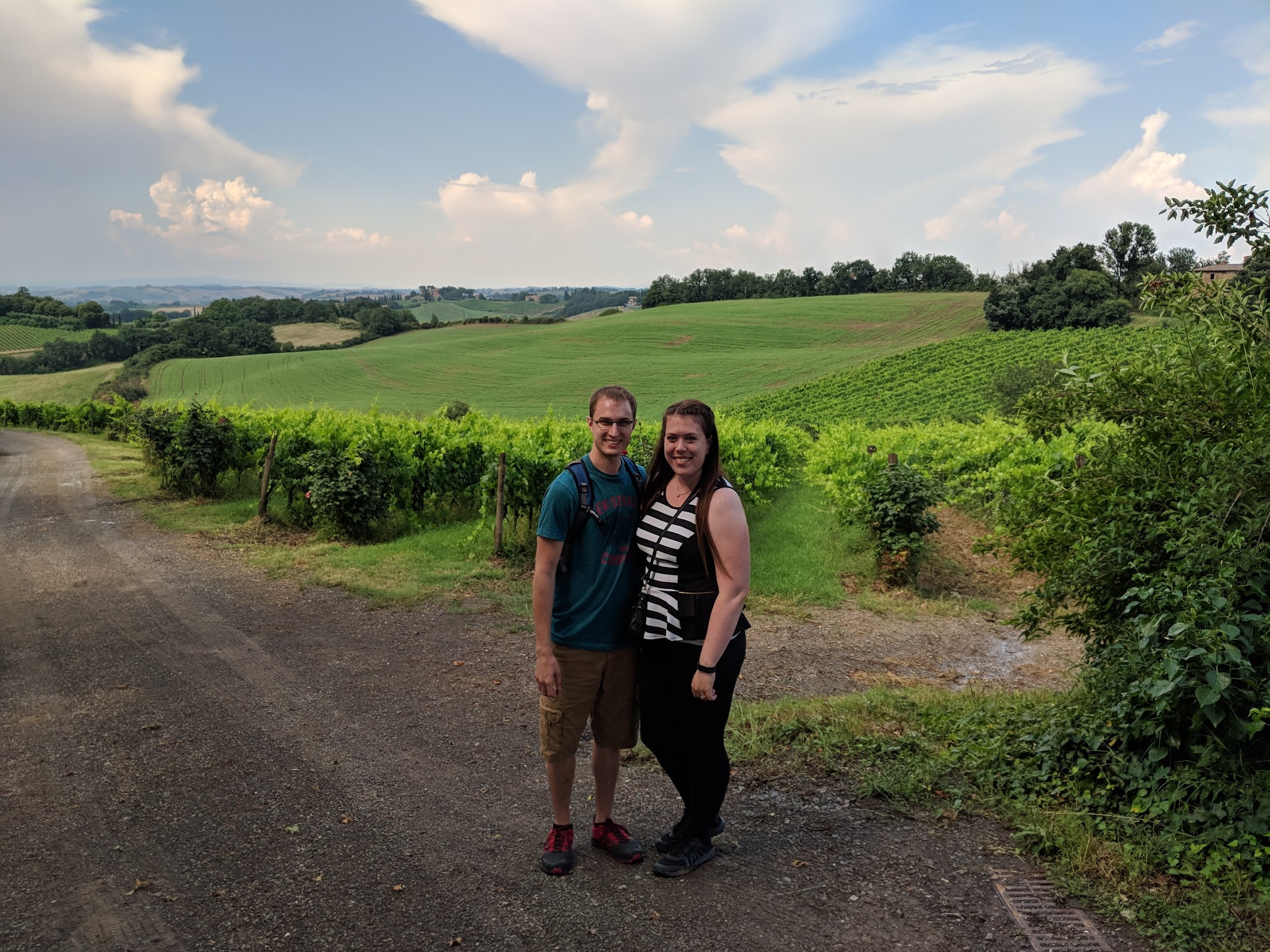 Man and woman standing in vineyard in Tuscany, Italy