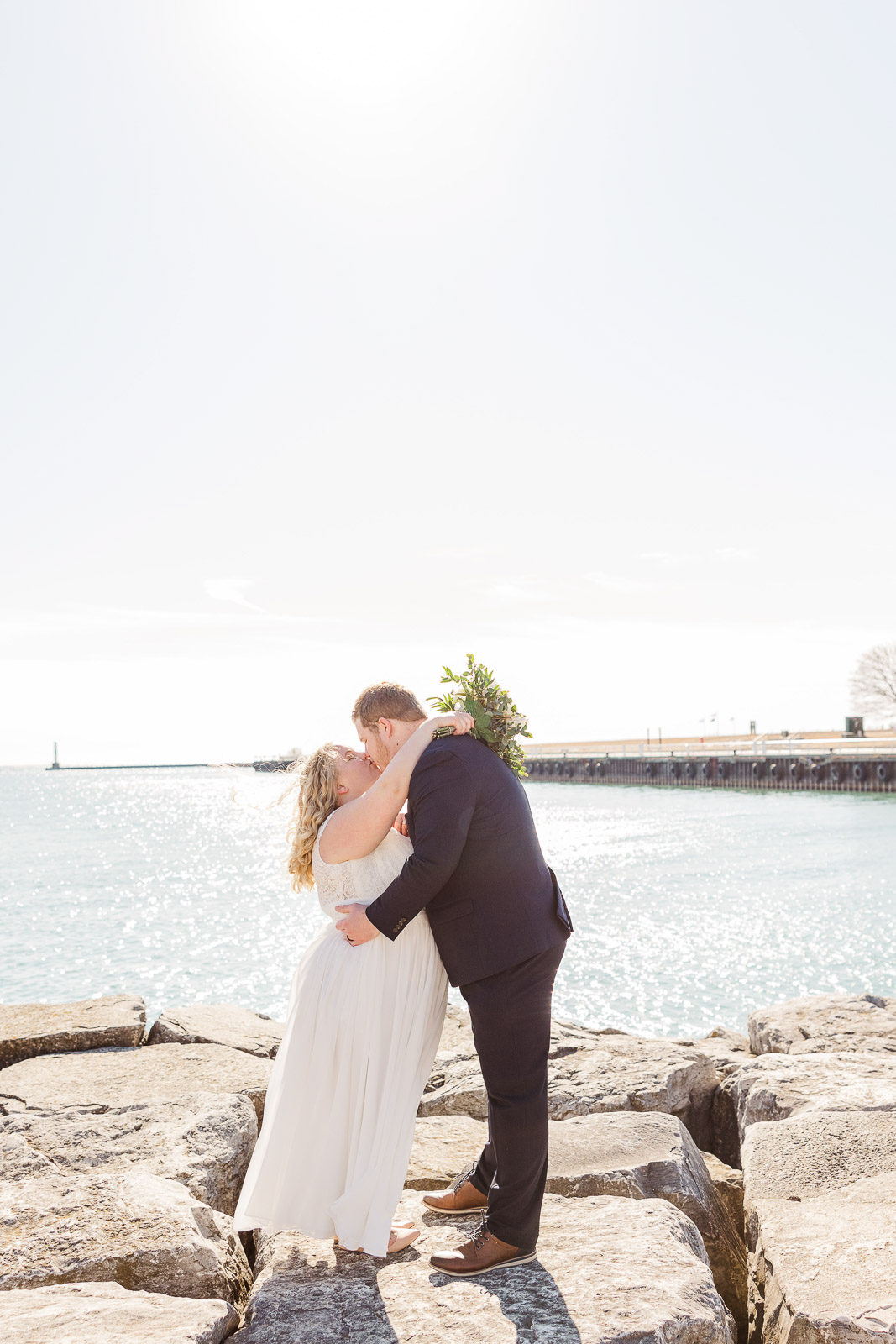 Bride and Groom kiss in front of Lake Michigan