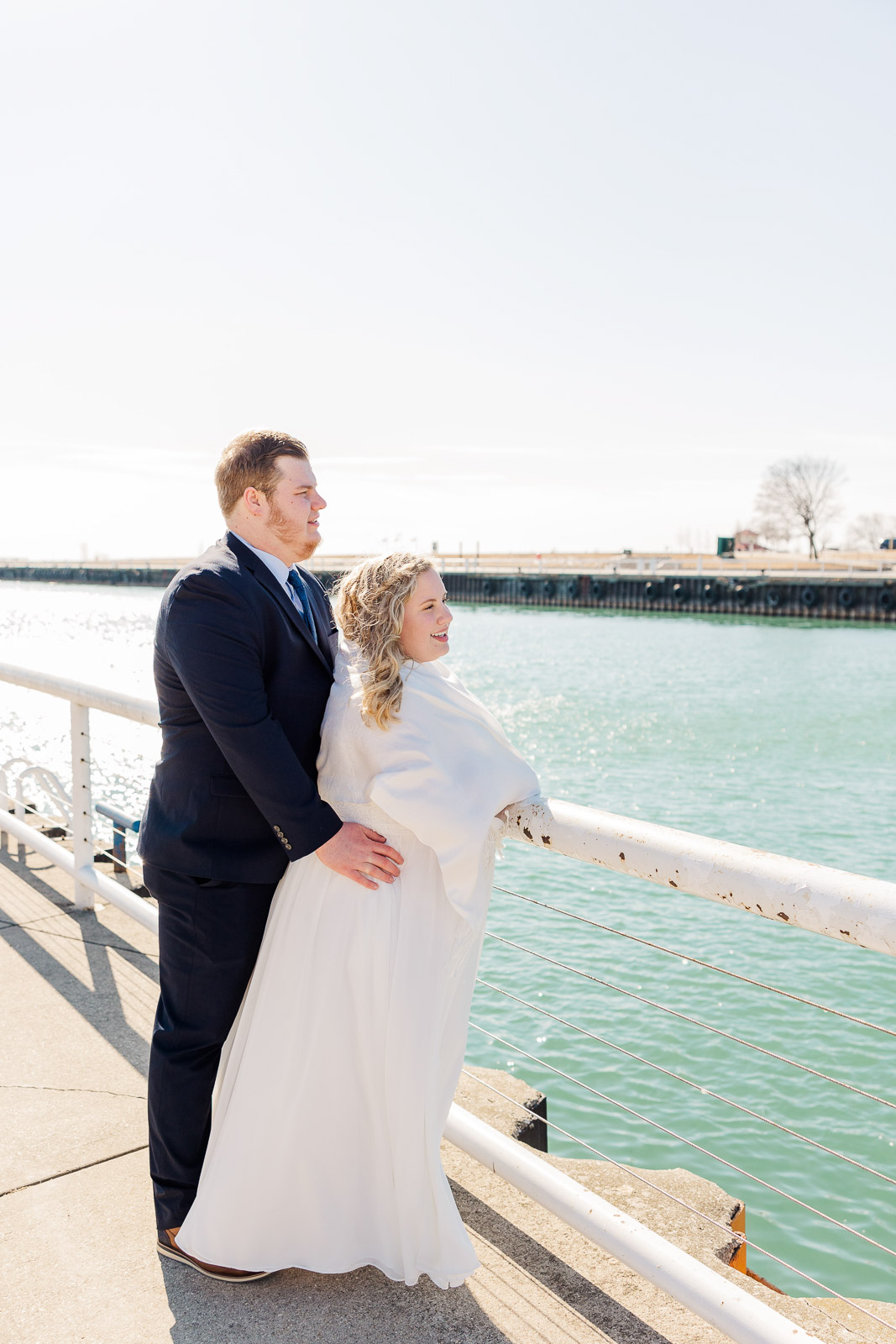 Bride and groom looking out at Lake Michigan