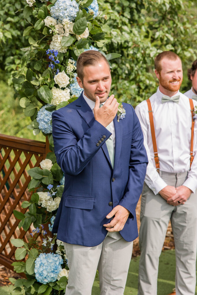 Groom seeing bride for the first time at wedding. 