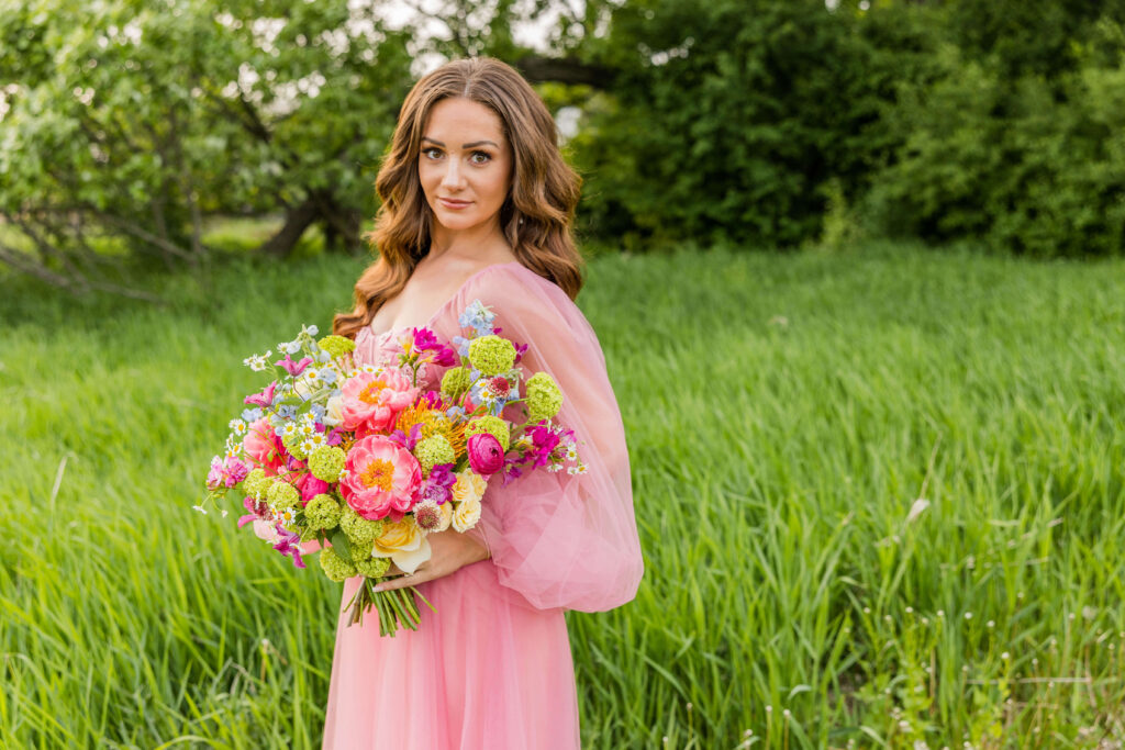 Stunning pink floral bouquet bride with pink ball gown with floral details in Wisconsin. 
