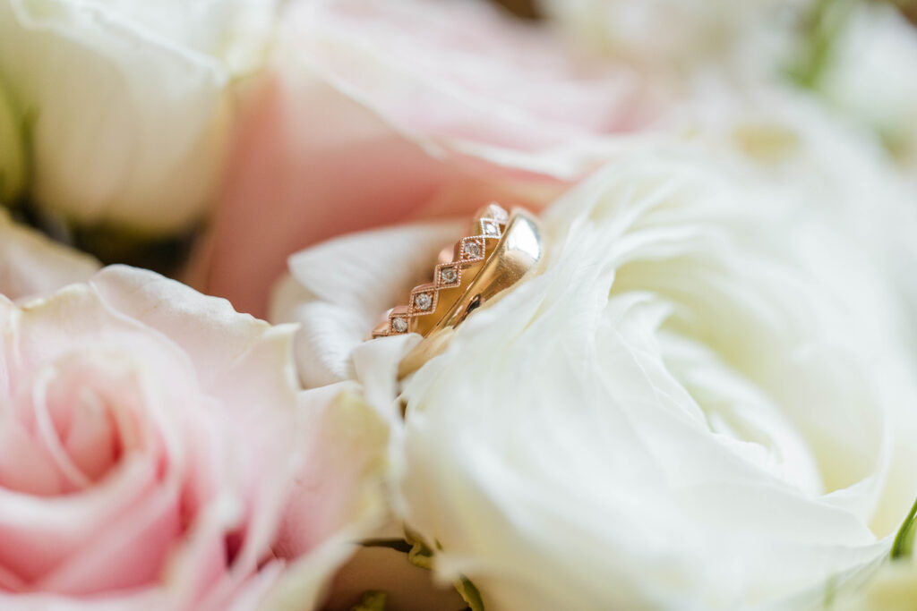 Wedding bands on top of florals.