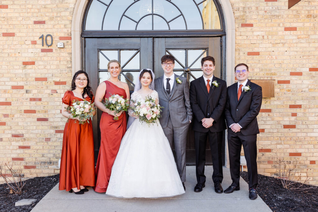Wedding party photo in front of 10 south in Wisconsin.