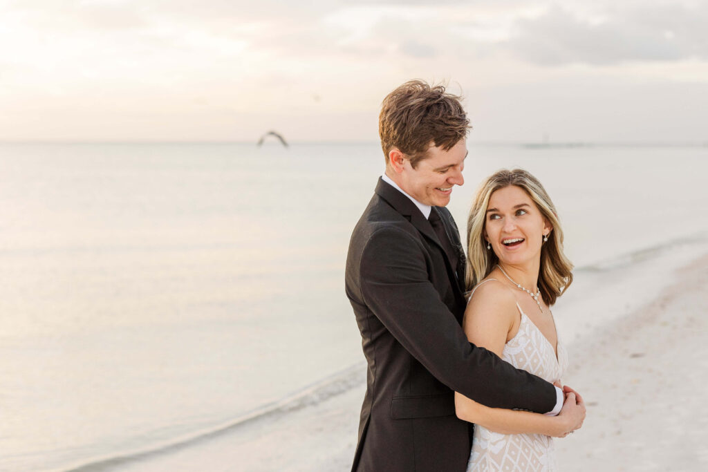 Couple laughing on the beach destination wedding in Florida. 